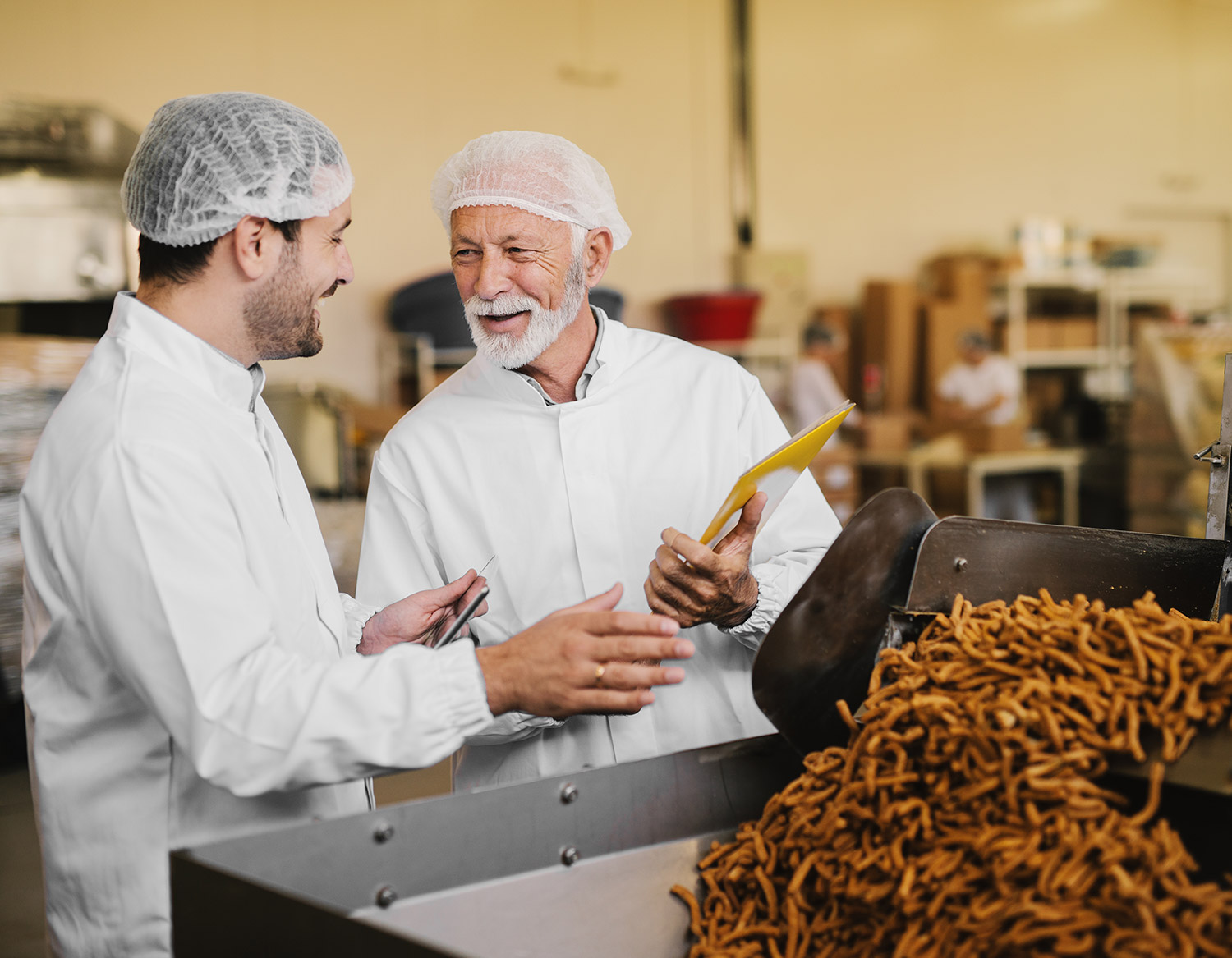 Two men in a food factory